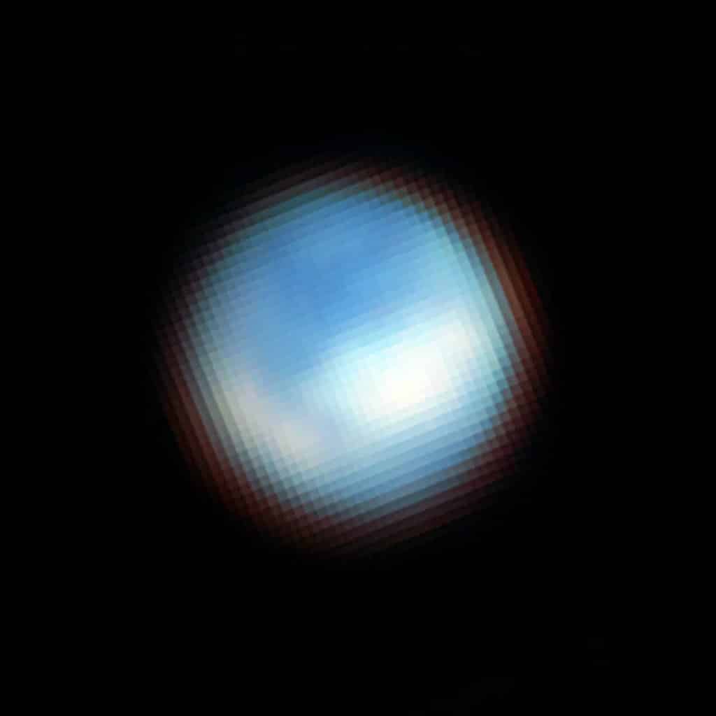 Imagen de Webb de la superficie de Europa, la luna de Júpiter, tomada con la cámara de infrarrojo cercano NIRCam. Webb ha identificado dióxido de carbono en la superficie helada de Europa, que probablemente se originó en su océano subterráneo. Este descubrimiento tiene implicaciones importantes para la habitabilidad potencial del océano de Europa. La luna parece azul porque es más brillante en longitudes de onda infrarrojas más cortas. Las zonas blancas se corresponden con el terreno caótico de Powys Regio (izquierda) y Tara Regio (centro y derecha), que muestran hielo de dióxido de carbono en la superficie.
