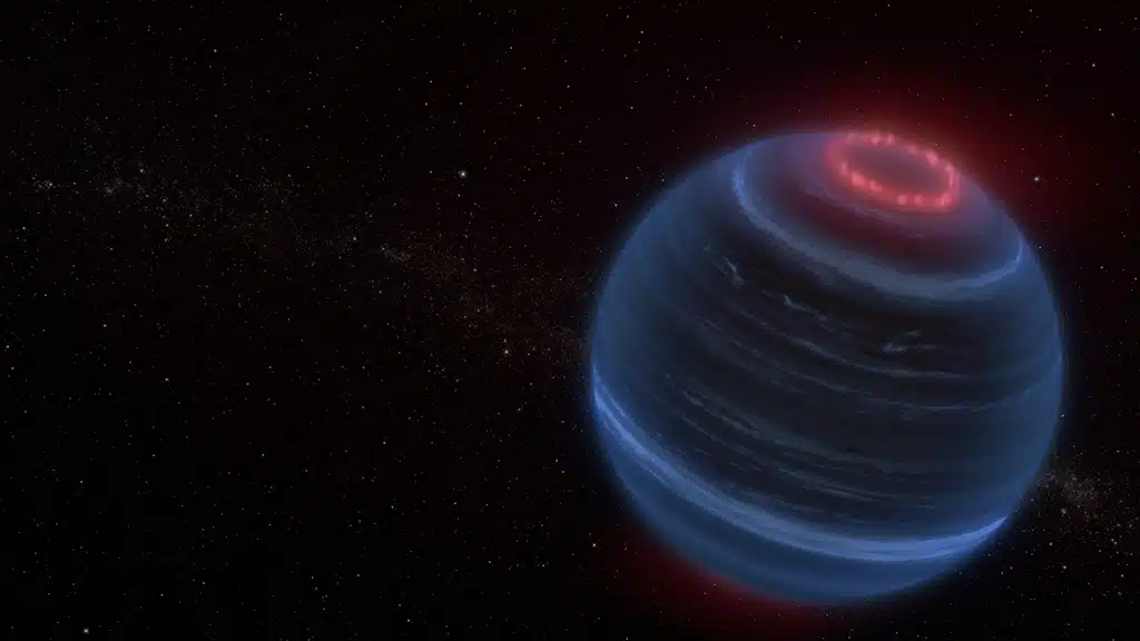 Concepto artístico que representa la enana marrón W1935, que se encuentra a 47 años luz de la Tierra. Los astrónomos que utilizaron el telescopio espacial James Webb de la NASA encontraron emisiones infrarrojas de metano provenientes de W1935. El equipo especula que la emisión de metano puede deberse a procesos que generan auroras, que se muestran aquí en rojo.