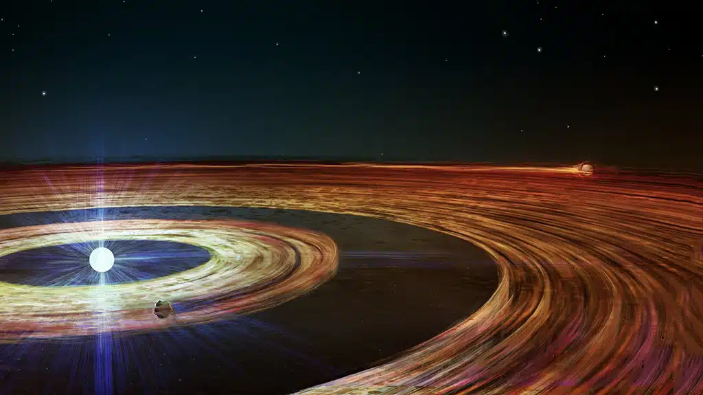 La ilustración muestra el disco de gas y polvo que rodea a la enana blanca J1328−1450, formado por los restos de su antiguo sistema planetario. Las observaciones con el instrumento X-Shooter del VLT revelan dos anillos gaseosos concéntricos, separados por un espacio y posiblemente mantenidos por dos planetesimales supervivientes: uno del tamaño de un asteroide y otro que podría alcanzar el tamaño de Plutón.